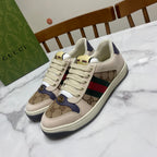 Gucci unisex sneakers, lace-up canvas, logo print panels and green-red stripe.