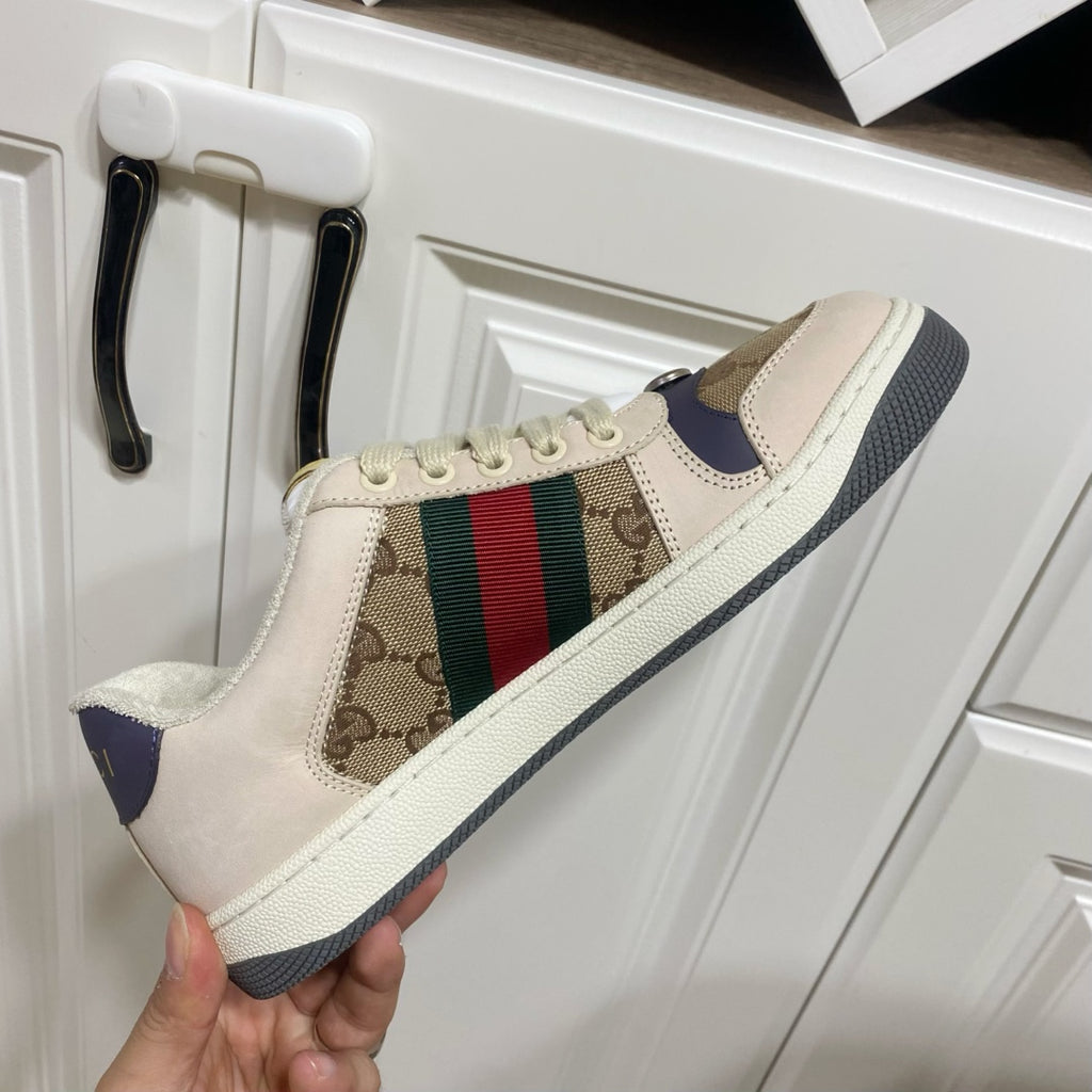 Gucci unisex sneakers, close side view, beige upper with logo panel and color stripe.