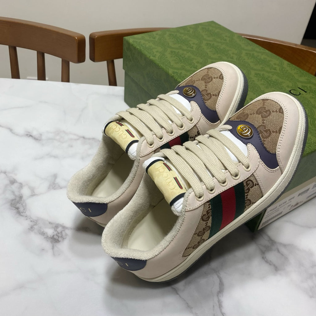 Gucci unisex sneakers, top view, beige uppers with logo print and multicolor stripe.