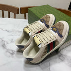 Gucci unisex sneakers, top view, beige uppers with logo print and multicolor stripe.