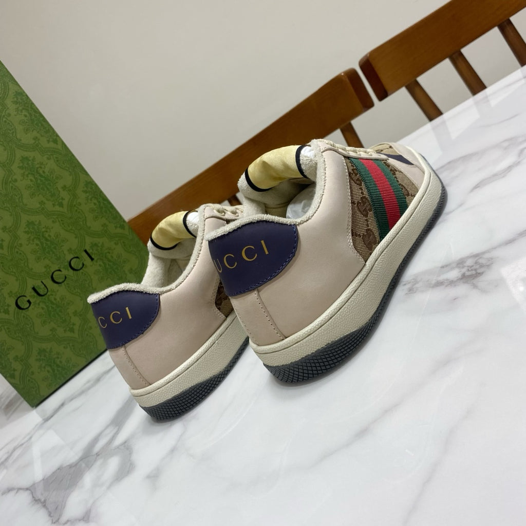 Gucci unisex sneakers, heel and side view, beige upper with logo patches and stripe.