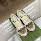 Gucci unisex sneakers, front view, white laces, logo toe panel and multicolor band.