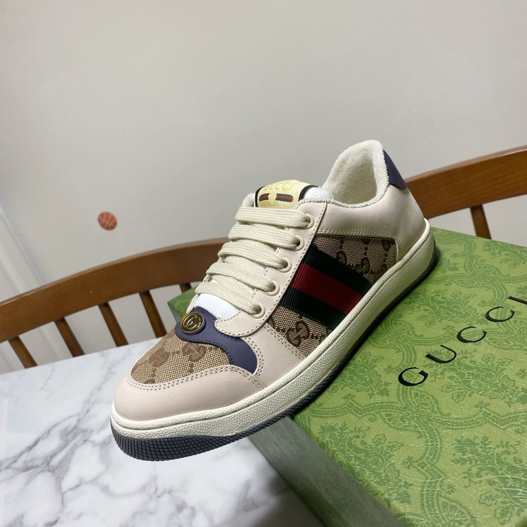 Gucci unisex sneakers, front side view, beige canvas with navy and green-red stripe.