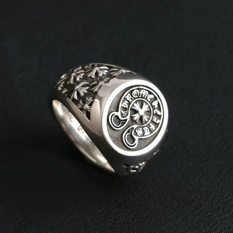 Chrome signet ring with oval emblem and carved floral pattern on band