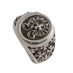 Chrome oval signet ring with etched floral leaves and raised emblem face