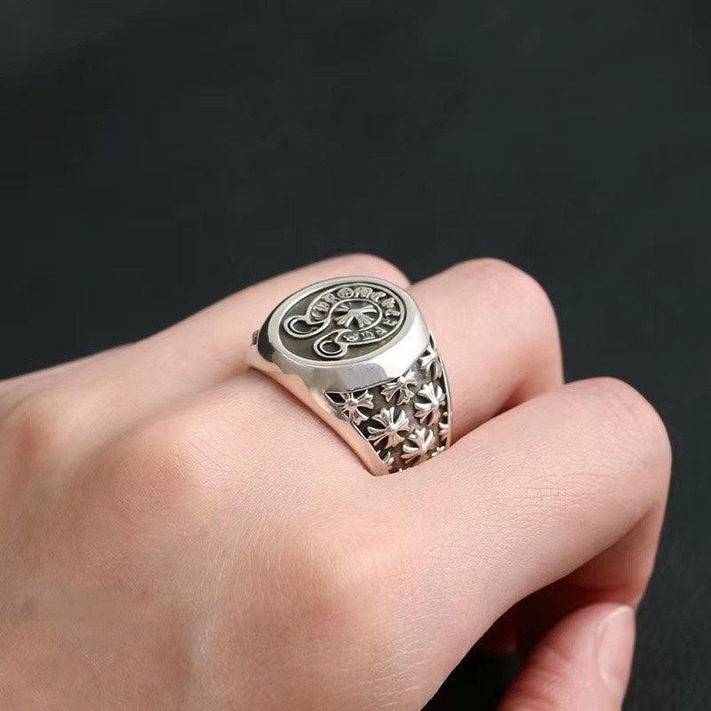 Chrome ring with oval crest, floral engravings, and decorative side details