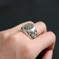 Chrome ring with oval crest, floral engravings, and decorative side details