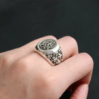 Chrome ring with oval crest, floral engravings, and decorative side details