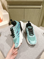 Pair of mint and black lace-up sneakers with white soles, side view