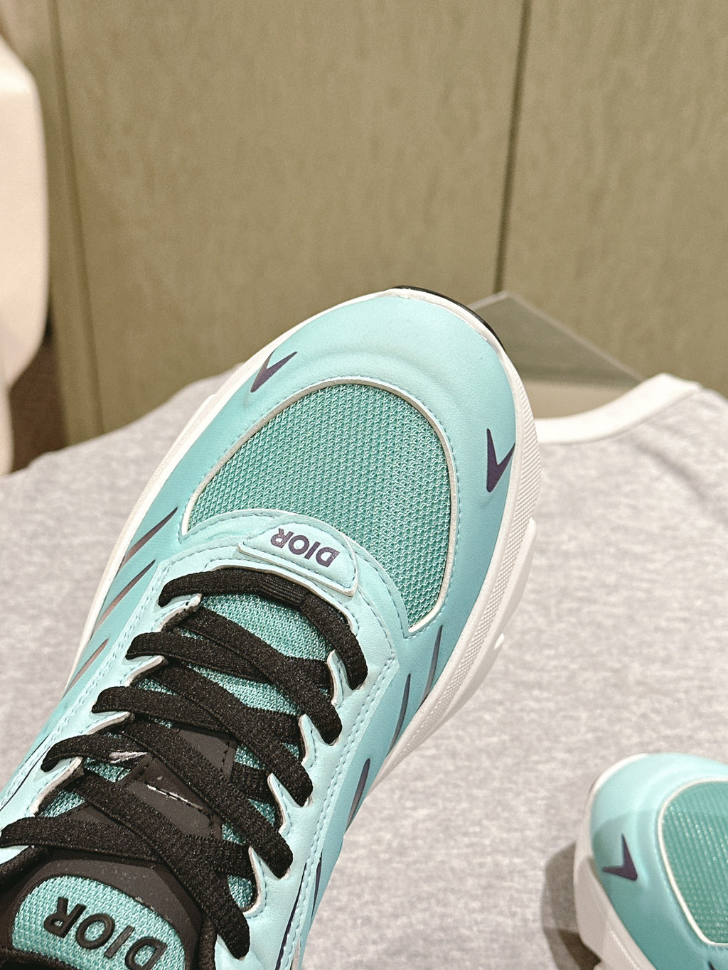 Mint sneaker toe and side panel with black laces and Dior logo label