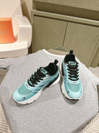 Mint and black lace-up sneakers with white midsoles and Dior branding on uppers