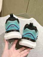 Back view of mint and black lace-up sneakers with white chunky soles