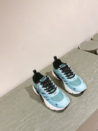 Two mint and black lace-up sneakers on a surface with black heel tabs