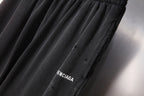 Black Balenciaga pants with logo print near side seam
