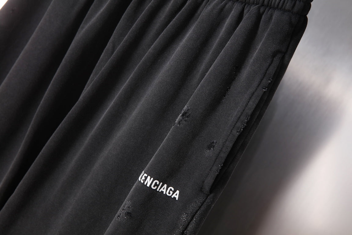 Black Balenciaga pants with logo print near side seam