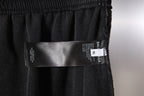 Black Balenciaga pants with care label on the front