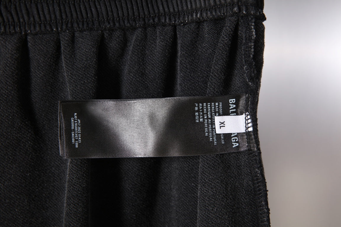 Black Balenciaga pants with care label on the front