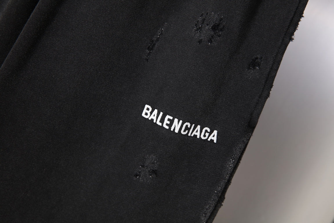 Black pants fabric close-up with BALENCIAGA logo embroidery