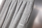 Balenciaga gray knit pants with gathered front pleats and logo detail