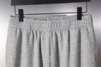 Balenciaga light gray sweatpants front view with elastic waistband and pleats
