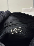 Black tote bag close-up of interior logo label