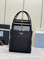 Black tote bag with top handles and front logo plaque