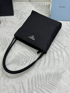 Black tote bag with long strap and front logo patch