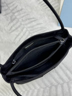 Black tote bag open view showing zipped inner compartments