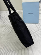 Black tote bag side view with long handle and stitched trim
