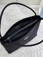 Black Prada tote bag interior view with two zip pockets and slip compartments.