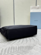 Black Prada tote bag with structured shape and wide bottom view.