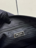 Prada interior logo plate on dark nylon lining near zipper and woven fabric texture