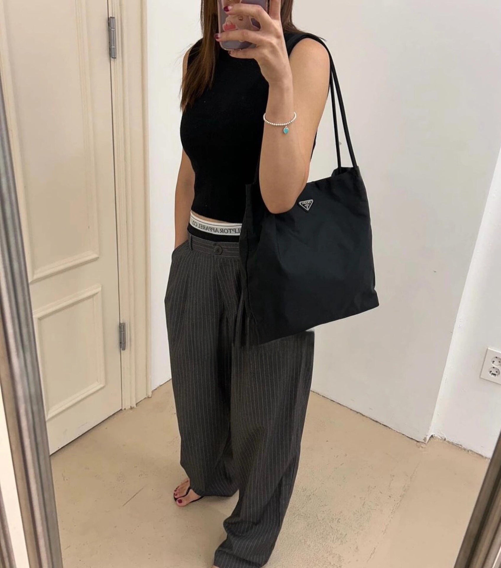 Prada nylon tote bag in black with triangular logo front and top handles