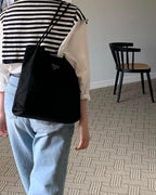 Prada nylon tote bag in black, triangular logo patch and top handles