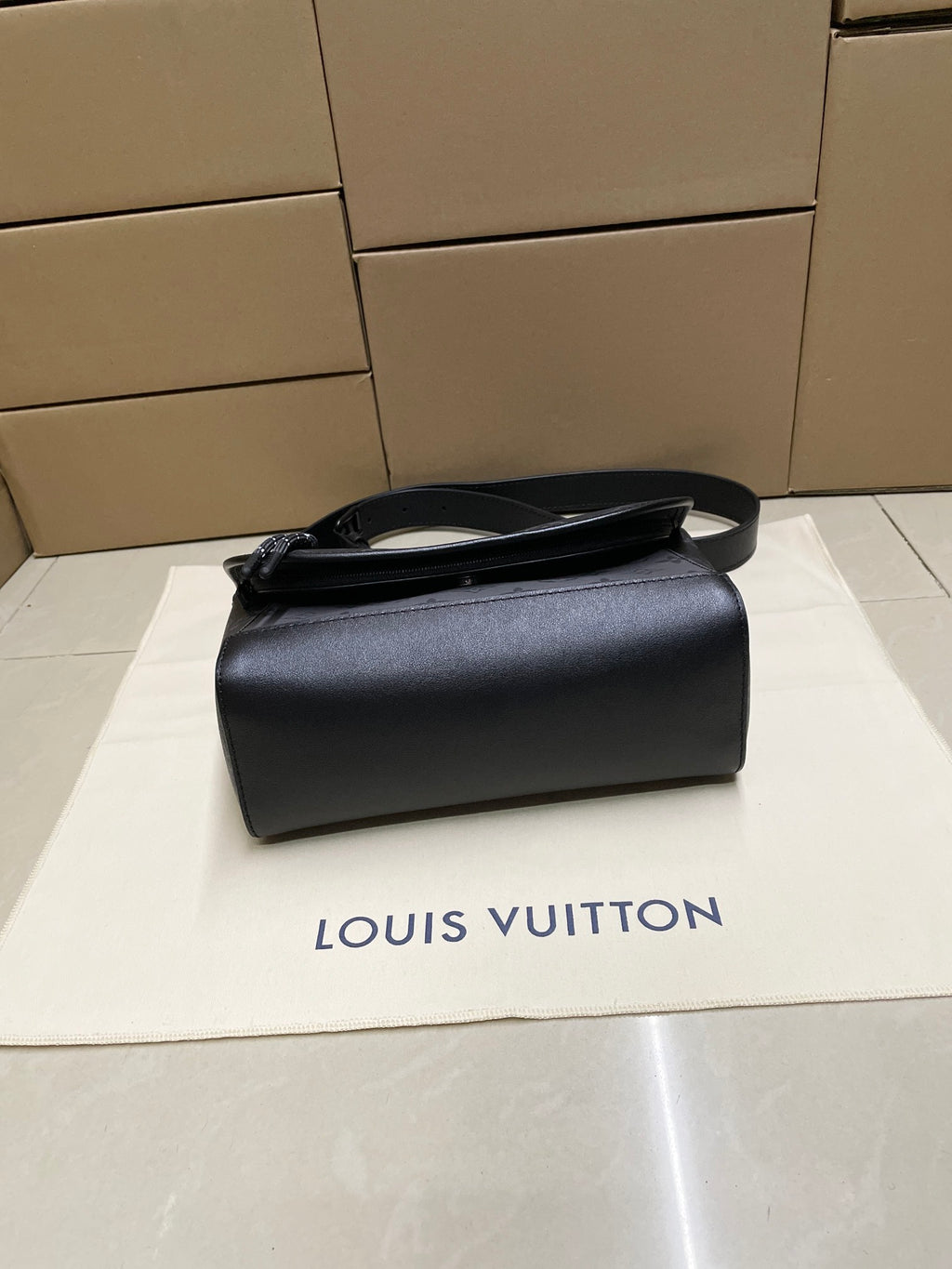 Louis Vuitton men's leather crossbody bag in dark gray with top handle strap