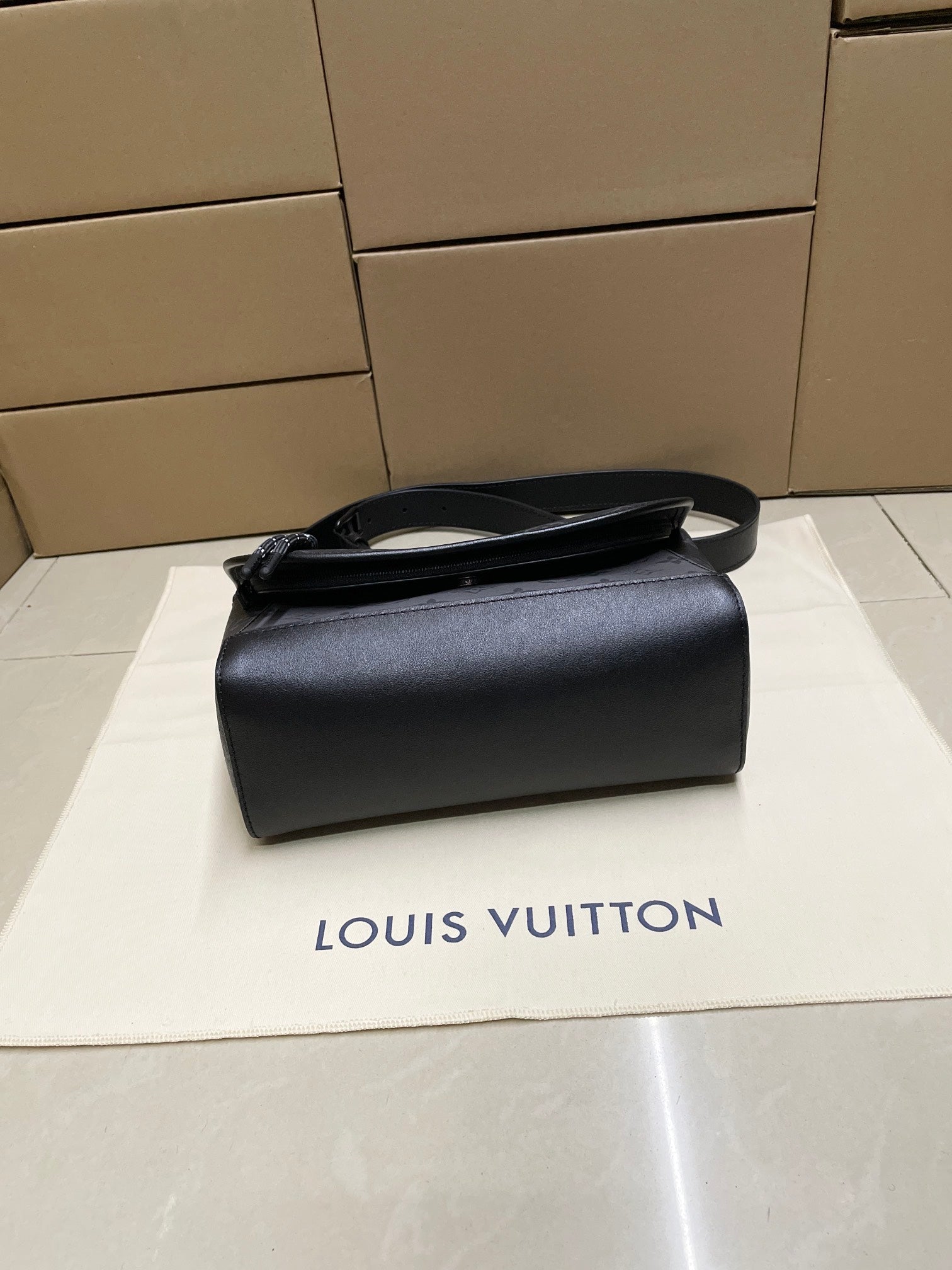 Louis Vuitton men's leather crossbody bag in dark gray with top handle strap