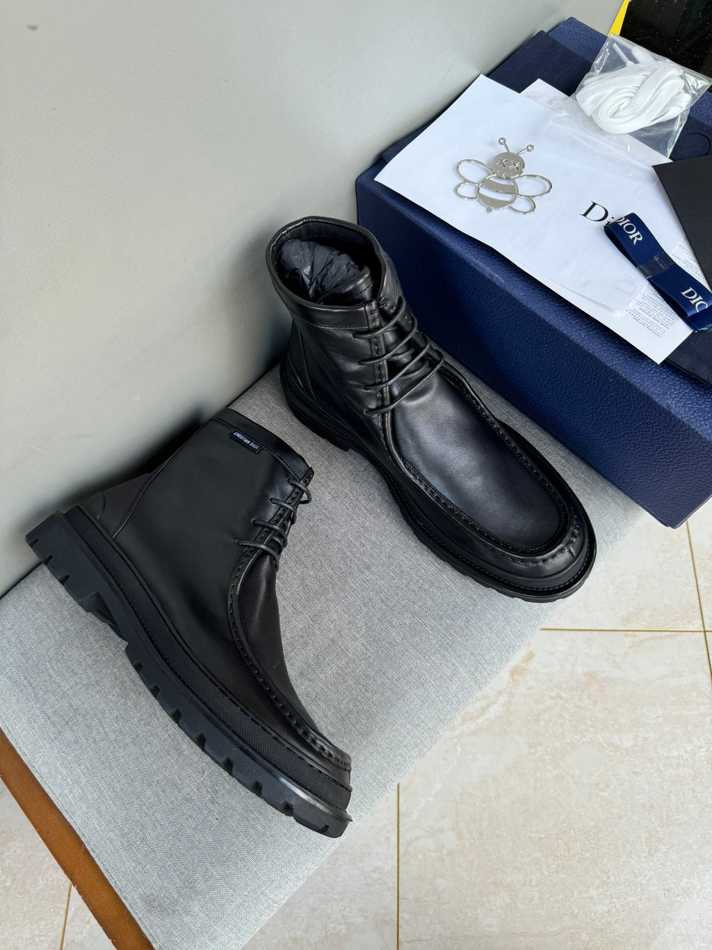 Black leather lace-up ankle boots, side view, thick tread sole
