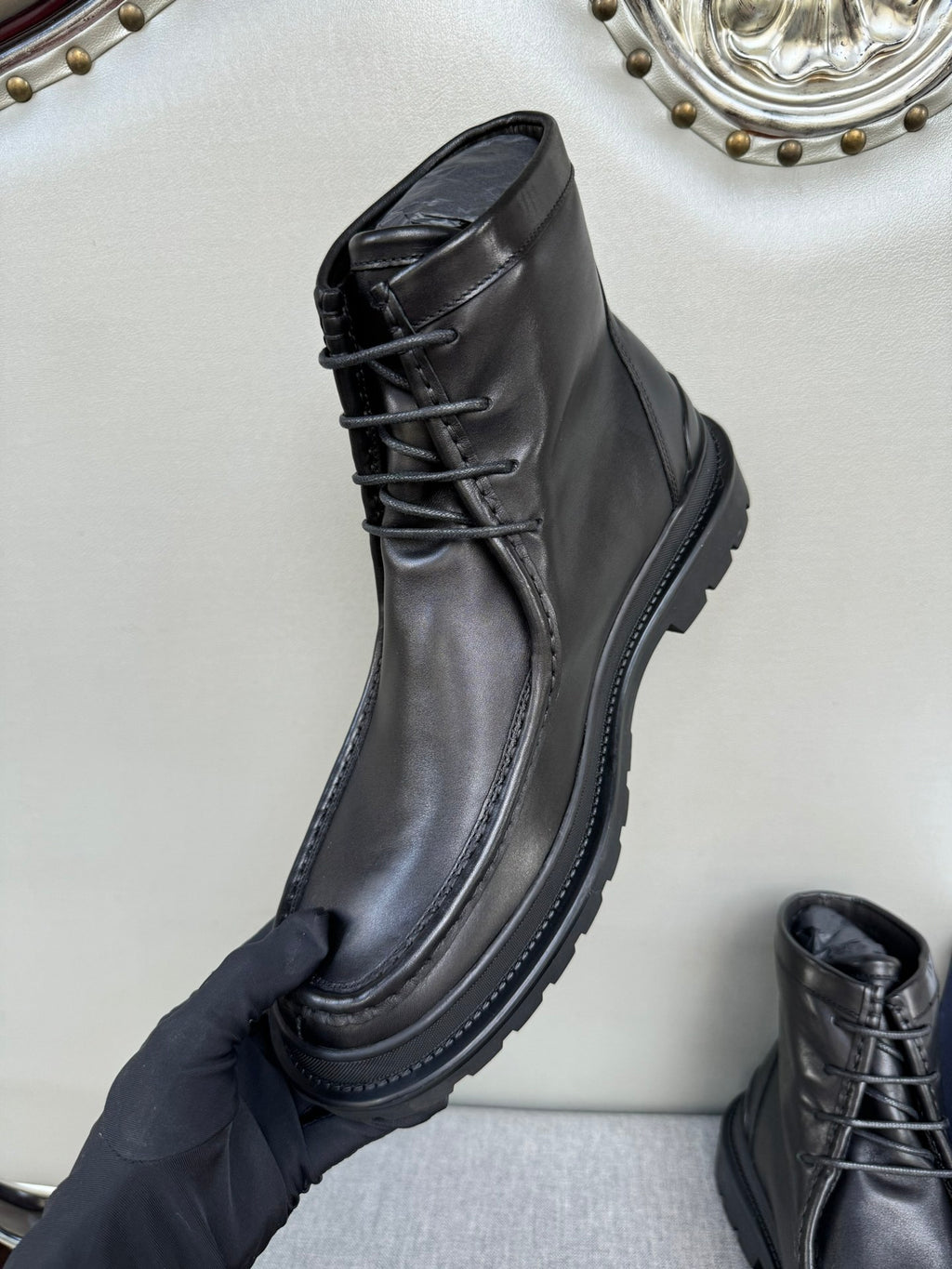 Black leather lace-up boot, upper and laces visible
