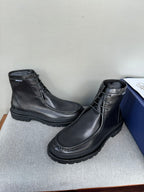 Black leather lace-up boots, angled view, chunky tread outsole