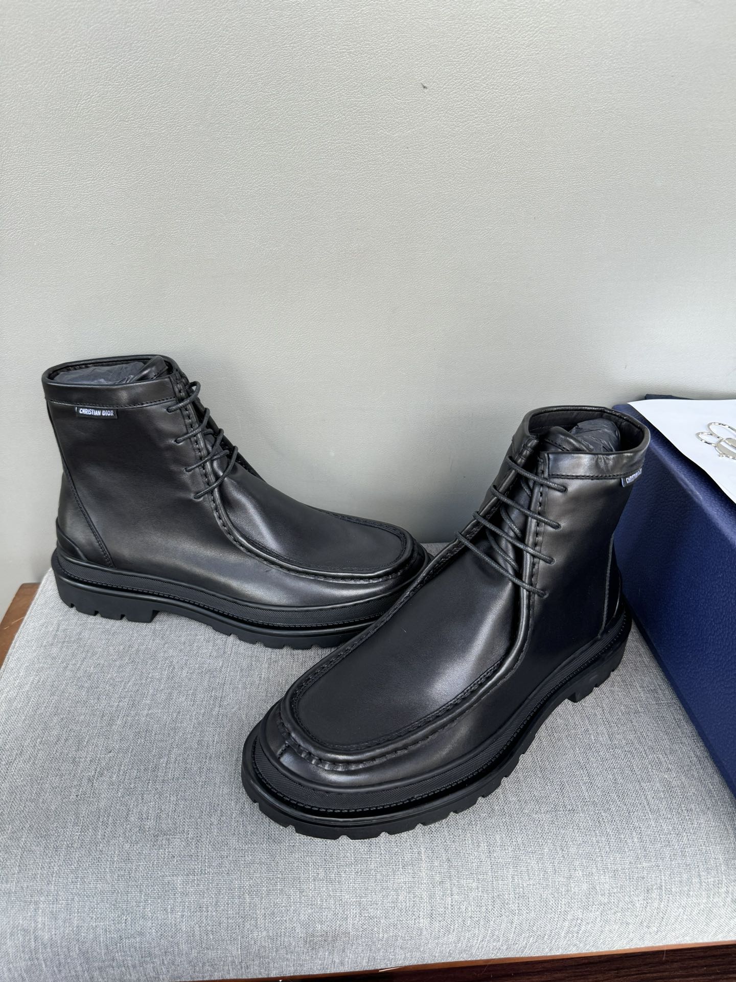 Black leather lace-up boots, angled view, chunky tread outsole