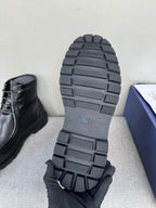 Black leather lace-up boot outsole and heel tread, bottom view