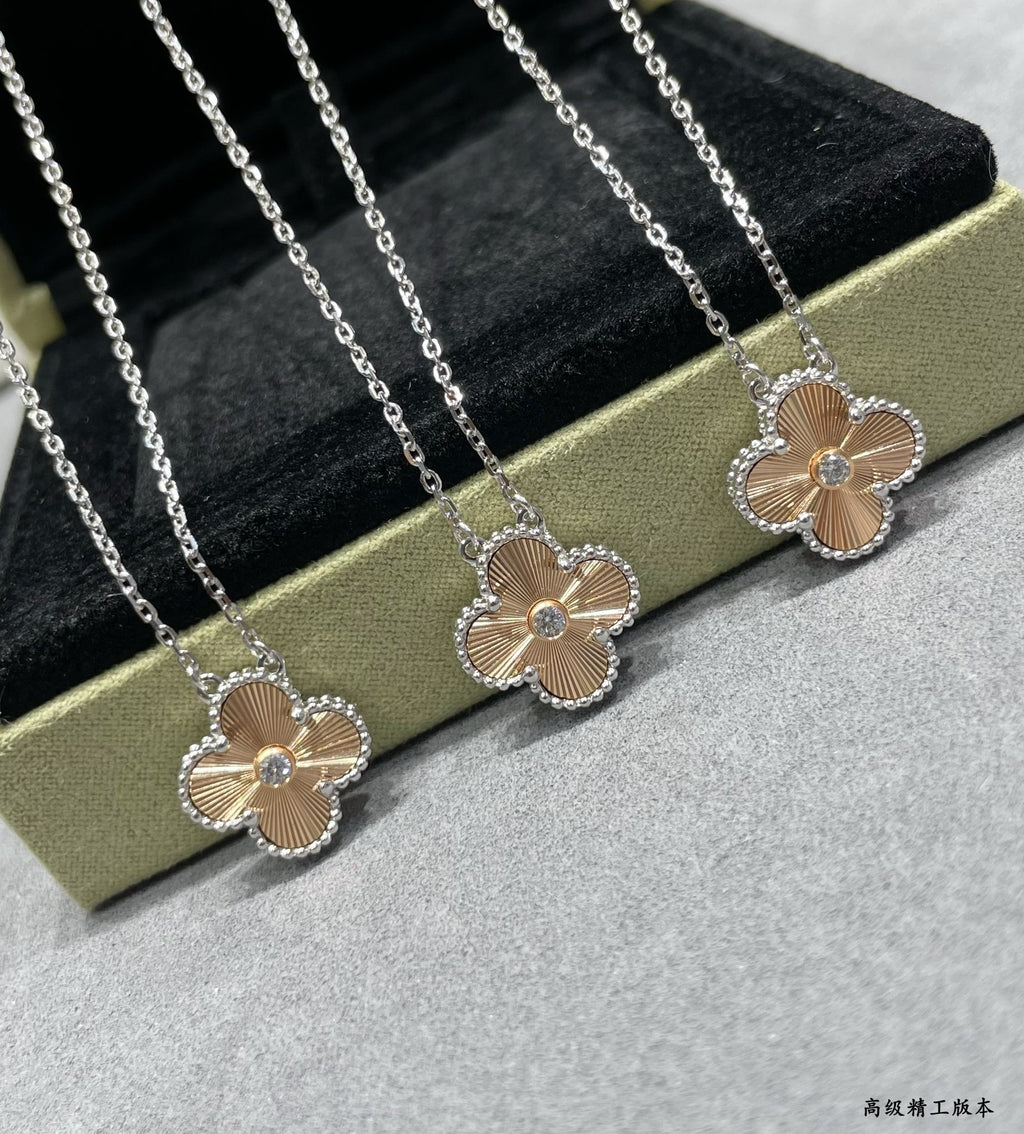 Two silver-tone flower pendant necklaces with round center stones