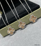 Two silver-tone flower pendant necklaces with round center stones