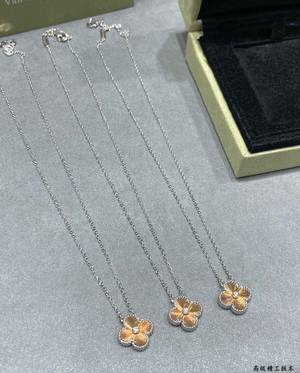 Set of silver-tone flower pendant necklaces on velvet display