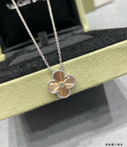 Silver-tone flower pendant necklace on display with link chain