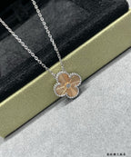 Silver-tone flower pendant necklace with crystal border and link chain