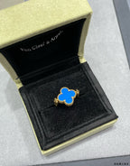Blue enamel clover-shaped ring in a gold-edged gift box