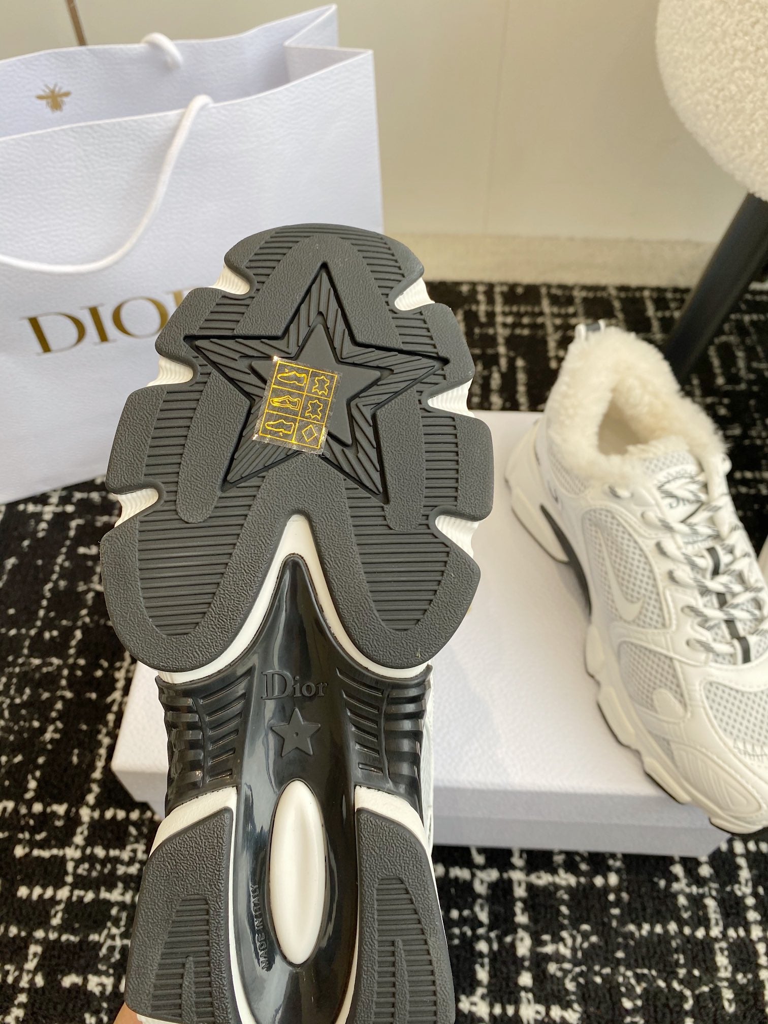 Dior unisex sneaker outsole with deep tread pattern and star emblem.