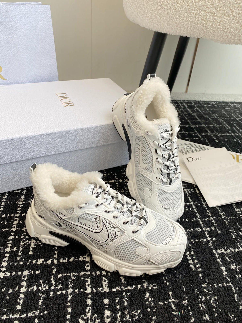 Dior unisex lace-up sneakers in white with faux shearling lining and cushioned collar.