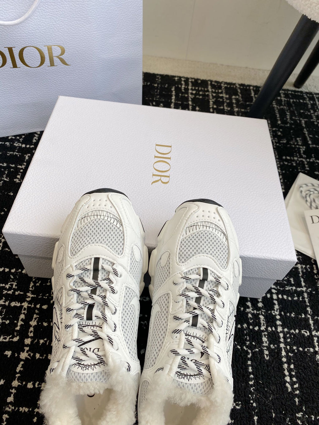Dior unisex white sneakers with lace-up eyelets and mesh toe panels.